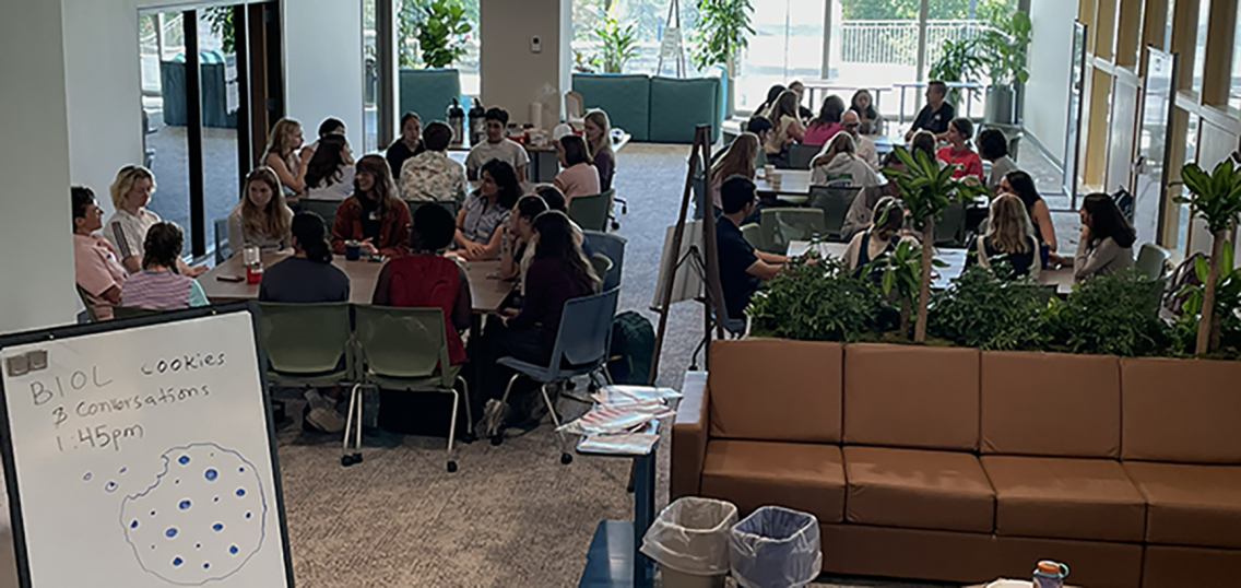 gathering of students and faculty at tables