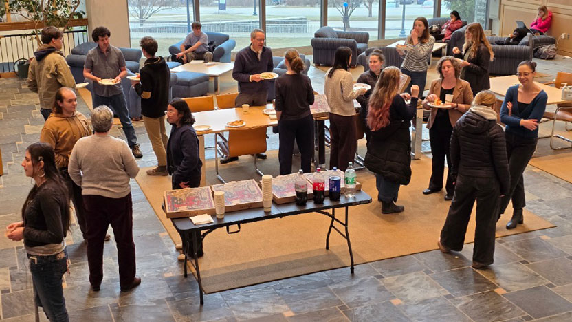 Students and faculty in the psychology department enjoying a pizza party in BiHall.