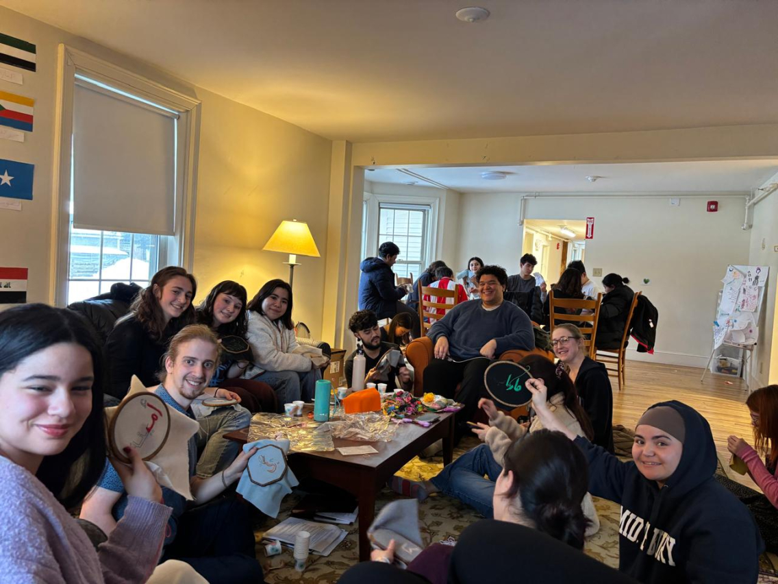 Arabic house students lead an embroidery activity.