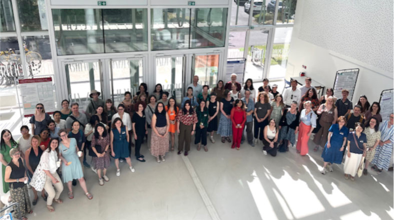 Conference attendees in a large group shot.
