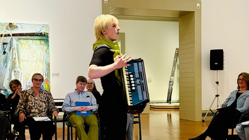 Madison plays the accordion as part of Beyond the Canvas.