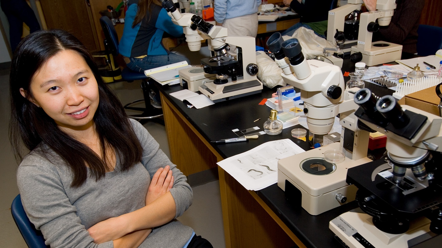 A women stands in the science lab where she is doing an internship with the help of Middlebury's Center for Careers and Internships.