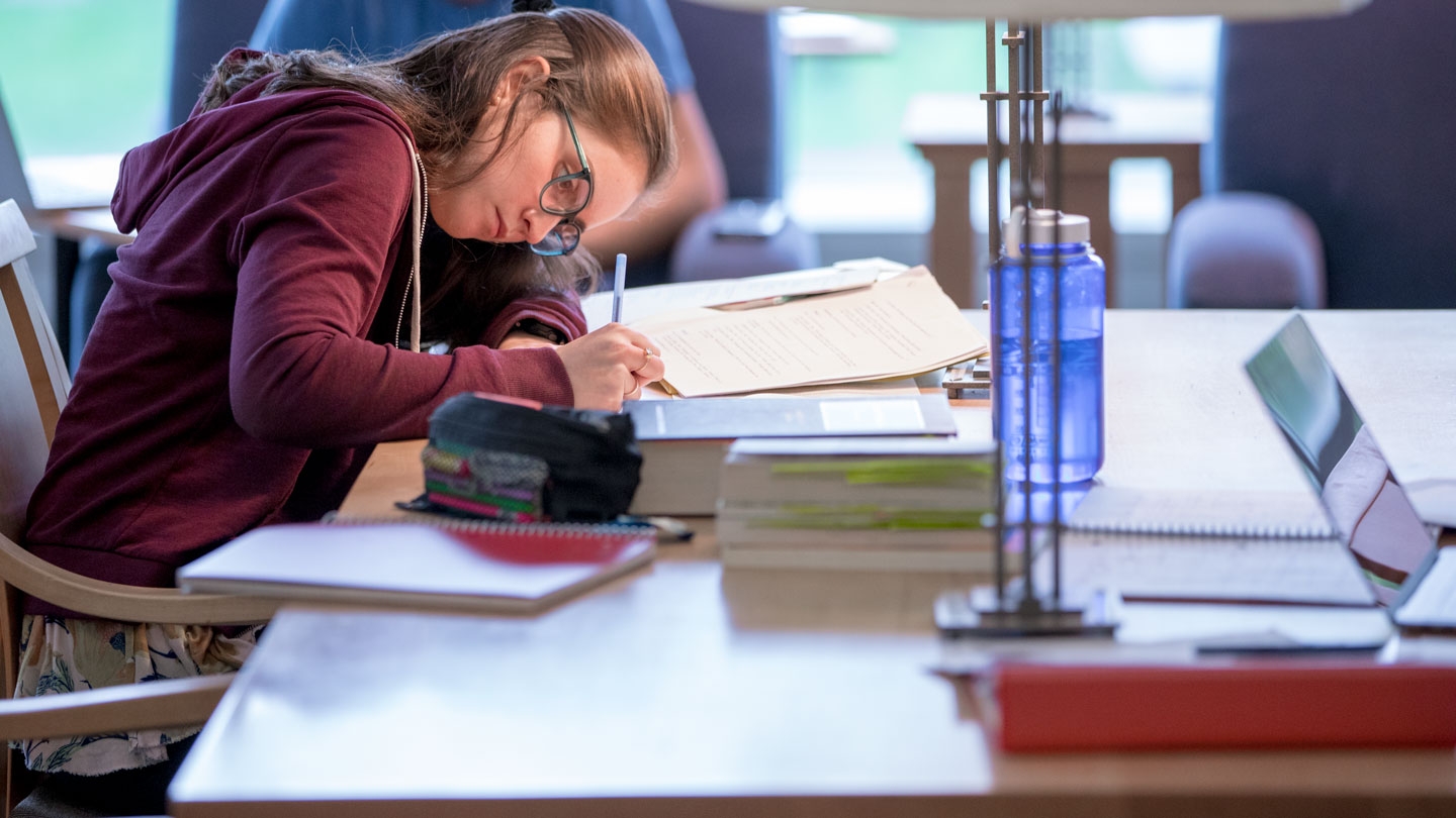 A religion student at work in the library.