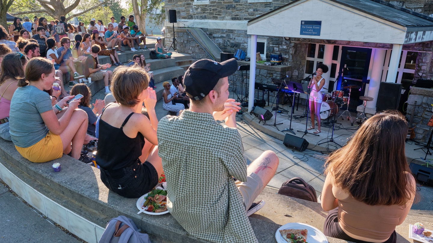 Students enjoy an outdoor performance on campus.