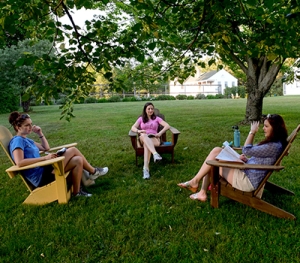 Three Bread Loaf School of English students talk outside.