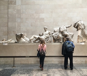 Two students examine statues in a museum in Oxford.