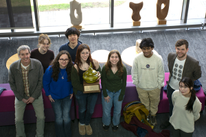 group photo of 7 students and 2 faculty looking up at the camera and smiling