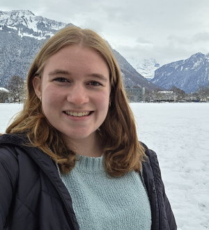 Person outside in the snow. Mountains in the background.