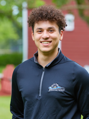 Photo of Ahmed Awadallah wearing a dark blue quarter-zip pullover. 