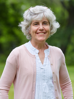 Photo of Kim Balparda wearing a white blouse with a light pink sweater.