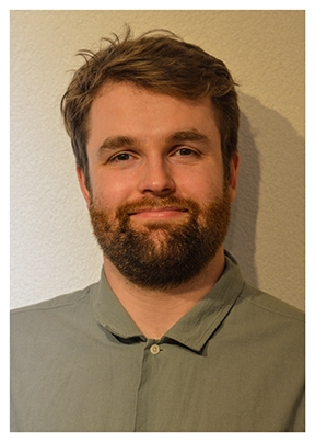 Man with brown hair and full beard