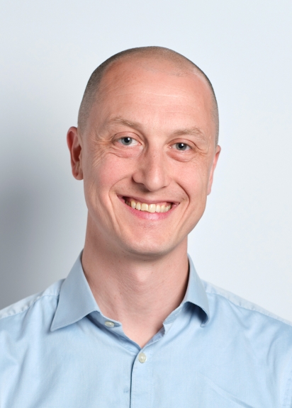 Man smiling in blue shirt