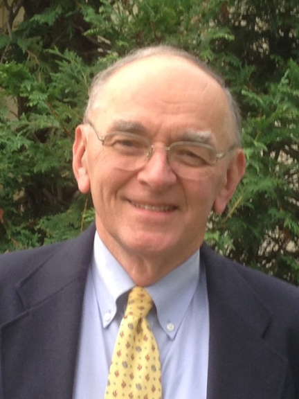 Headshot of John Emerson smiling, wearing a tie and jacket