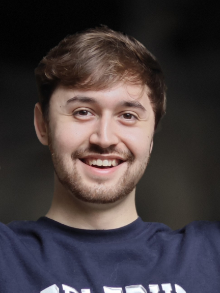 Smiling man with brown hair and eyes