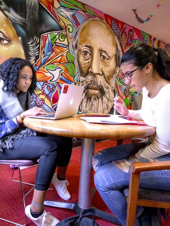 Two students studying at a table.