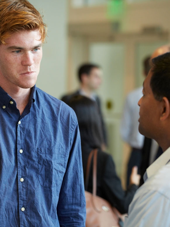 A student talks with a panelist during a career event on campus.