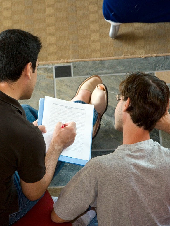 A tutor works with a student on a piece of writing.