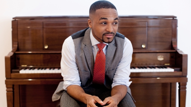 Jazz pianist Sullivan Fortner sitting at an upright piano