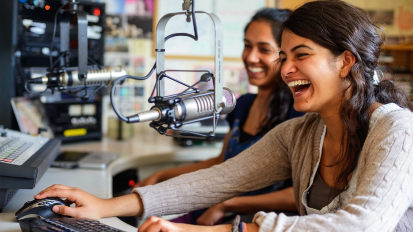 Two students at microphones host a podcast for WRMC, Middlebury's student-run radio station.