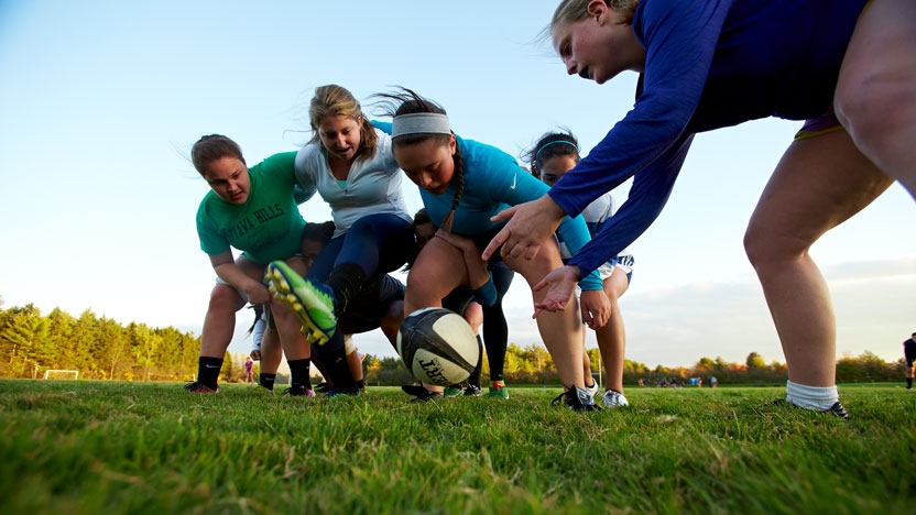 The womens rugby team in a scrum.