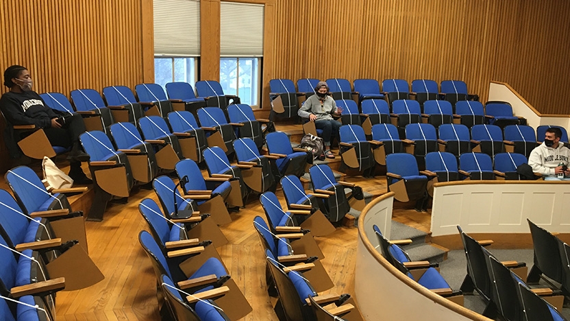 Students sit in classroom to prep for in-person presentations.