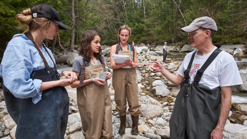 Professor leading field work on the river.