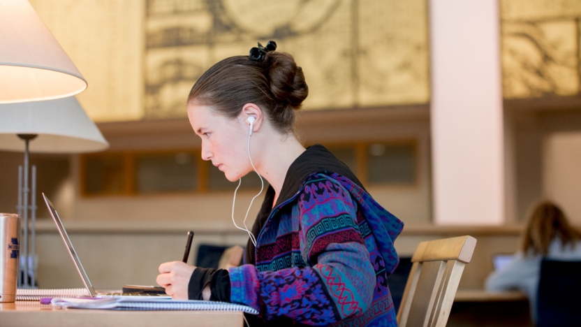 Student writing in the Library.