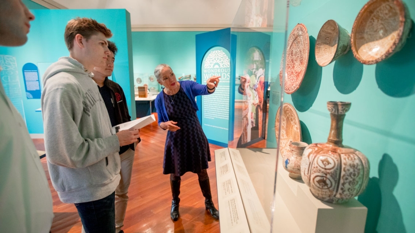 Students with Professor Packert viewing an exhibit in the Museum.