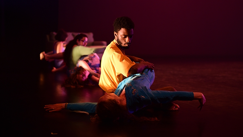 Two dancers perform on stage.