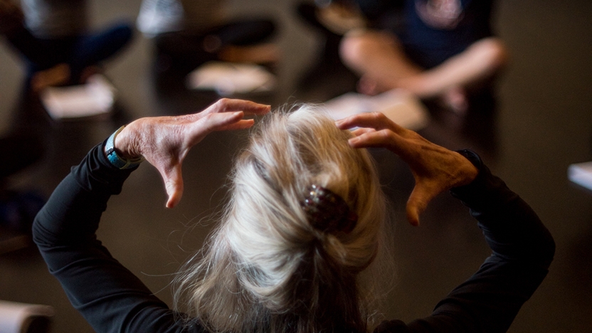 An instructor teaches a cloass about movement.