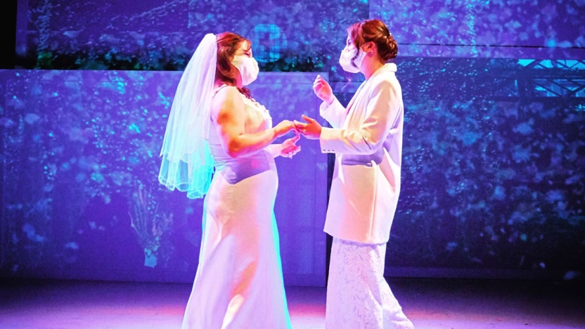 Two actors pretend to marry on stage