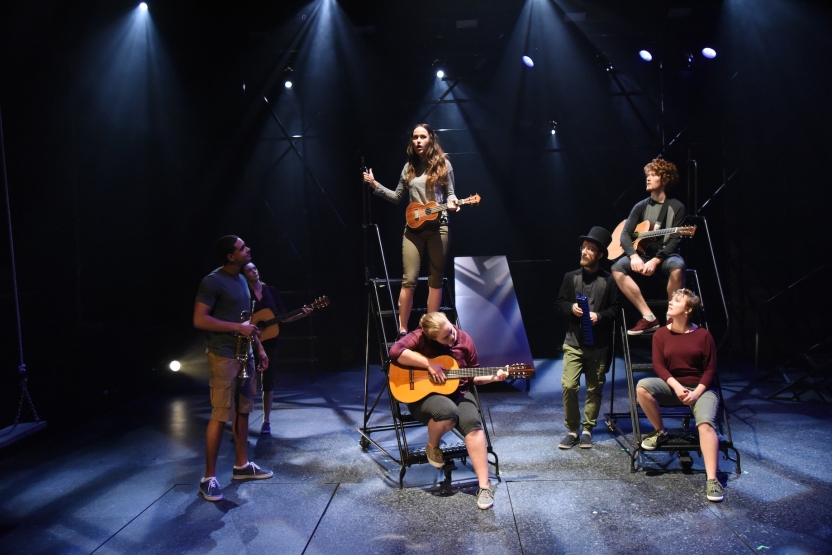 Actors with instruments sitting on step-ladders