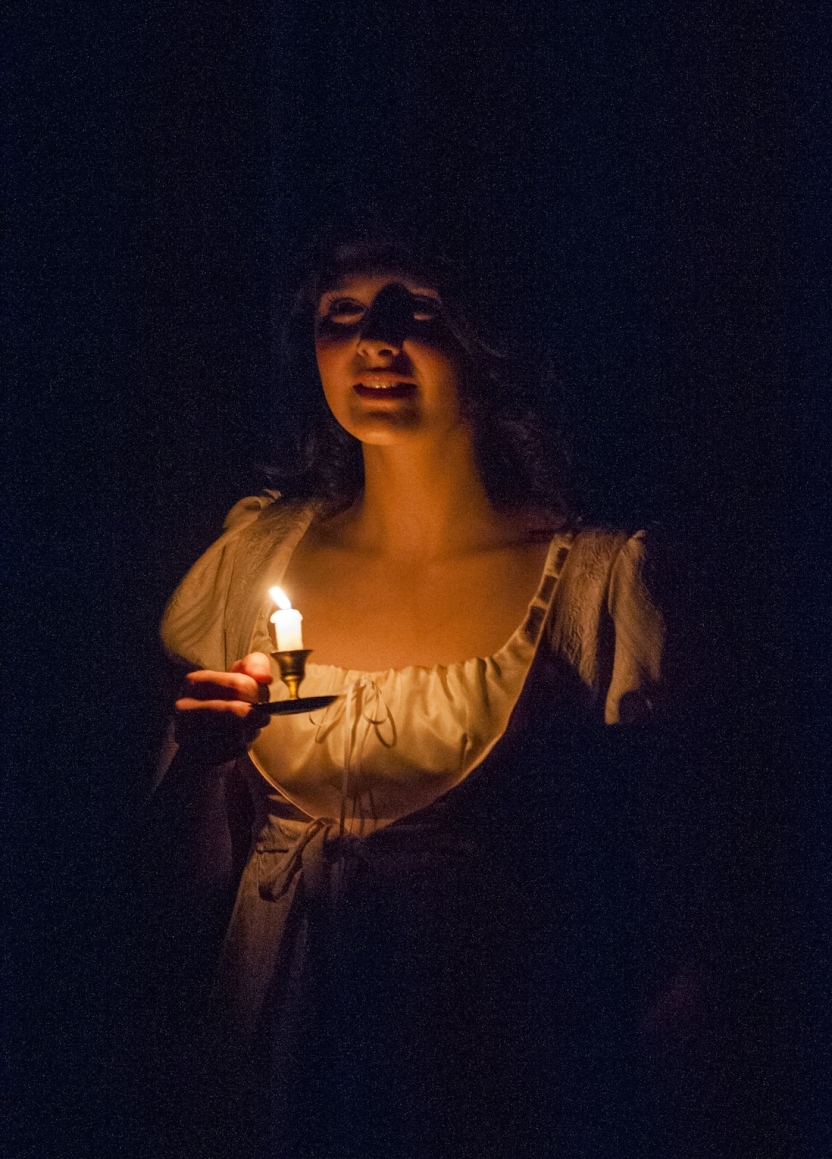 Actress holding a lit match