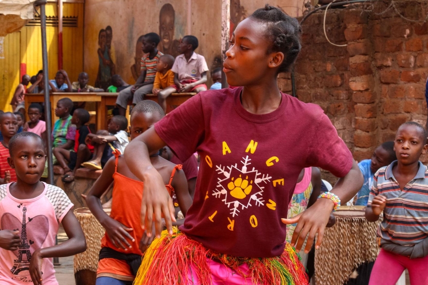 A girl dances in a circle of children