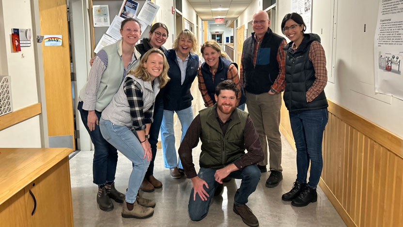Chem faculty posing casually in the hallway outside of the labs.