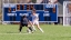A close up of two women playing in a varsity soccer game on the Middlebury field. 