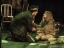 An actor crouched down to console a frightened actress