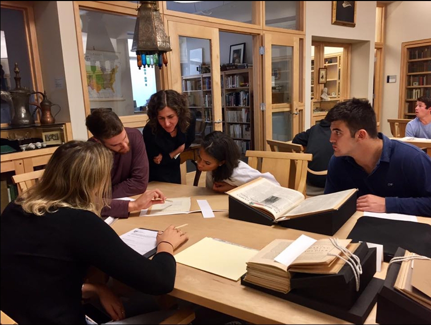 Students and Special Collections Curator Rebekah Irwin examine rare documents in the Library.