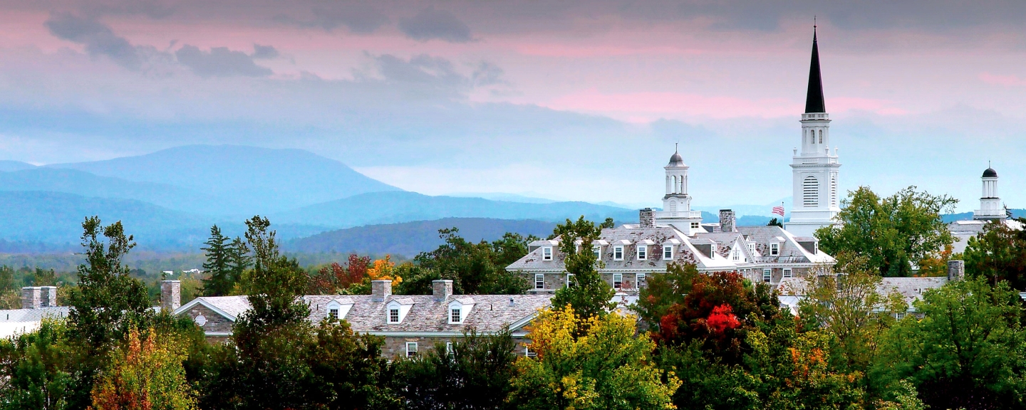 Panoramic view of Middlebury College sunset, with pink glow over the Green Mountains.