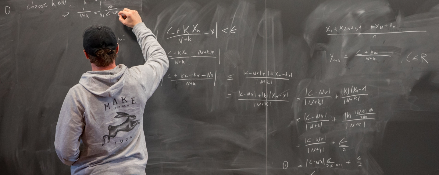 Student at a chalkboard.
