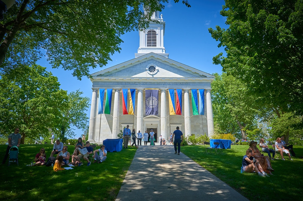 A view of Middlebury Chapel on the hill, with colorful Commencement banners.