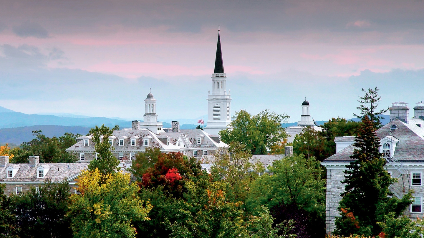 Panoramic view of Middlebury College sunset, with pink glow over the Green Mountains.