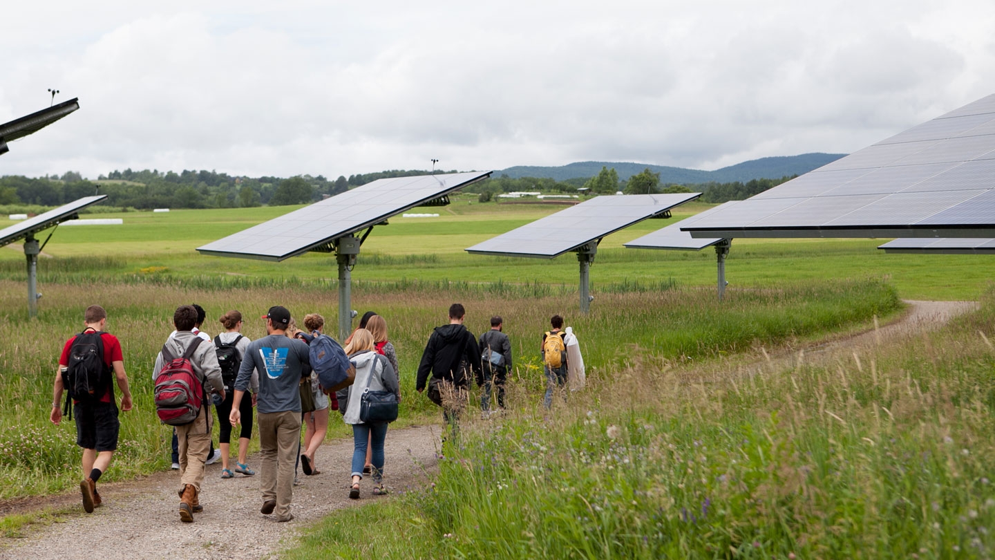 Students walking through the solar farm on campus.