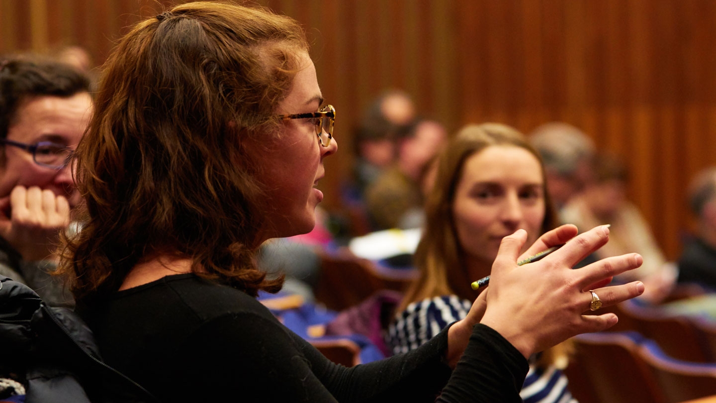 A student participates in an economics conference.