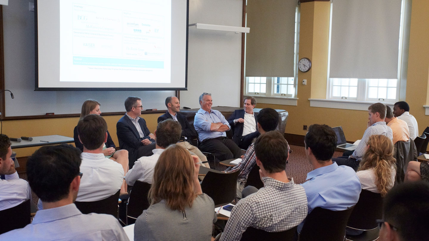 Students participate in a panel discussion with professional in the business consulting field.