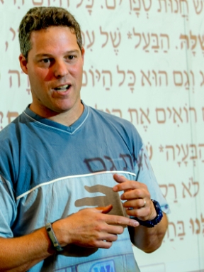 Language School instructer in front of class with Hebrew projected on screen