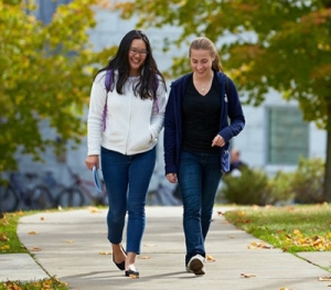 Two Middlebury students walk across campus.
