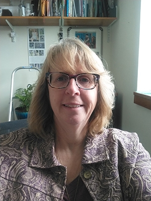 Woman with medium length blonde hair and glasses