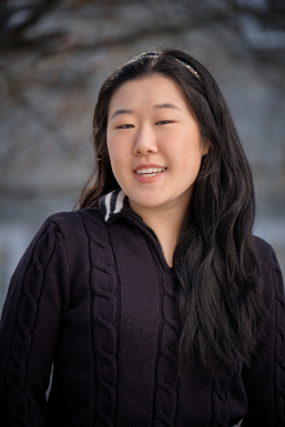 Photo of Josie Chun in a black sweater in front a snowy background. 