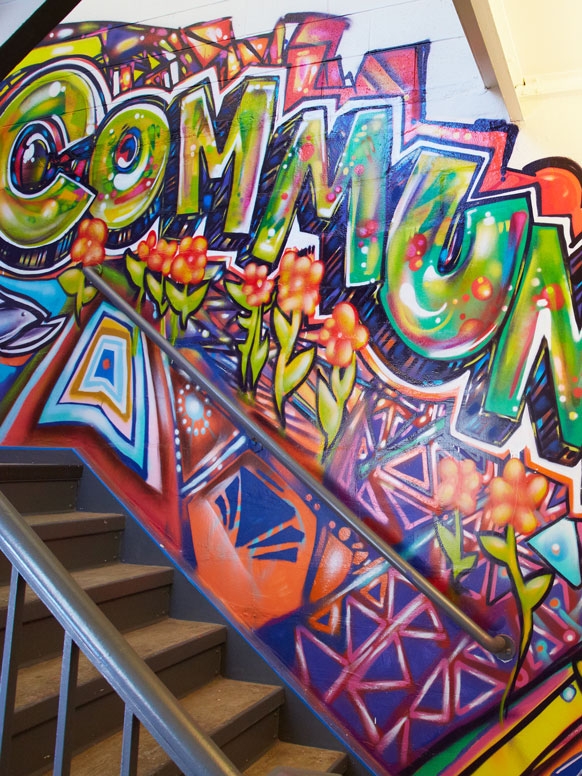 Mural that says "community" in a graffiti style.